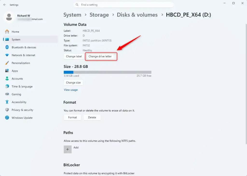 Changing drive letters via Windows 11 Settings menu interface.