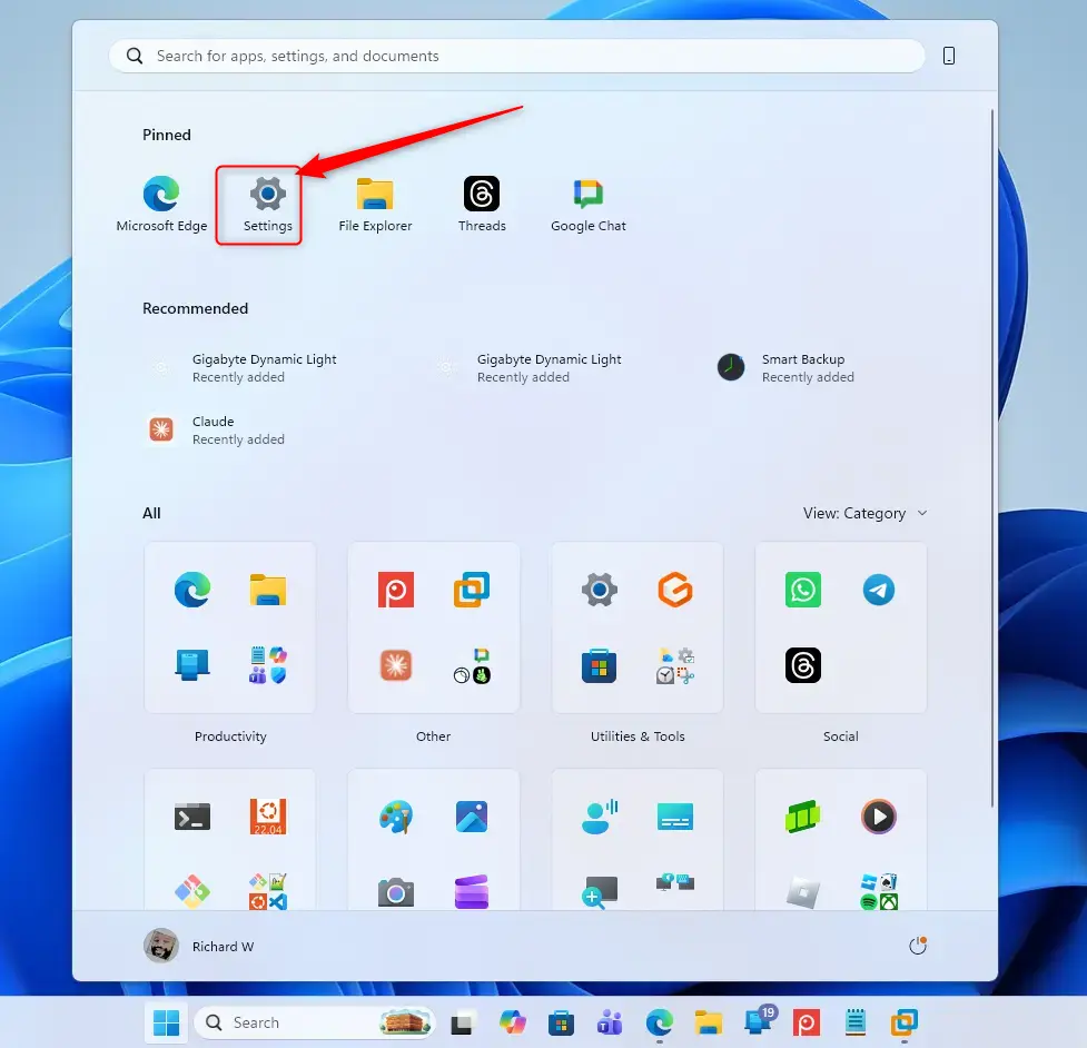 Windows 11 Start menu with Settings gear icon highlighted.