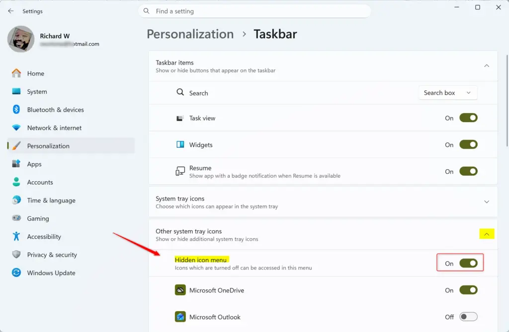 Windows 11 taskbar hidden icon menu with upward arrow