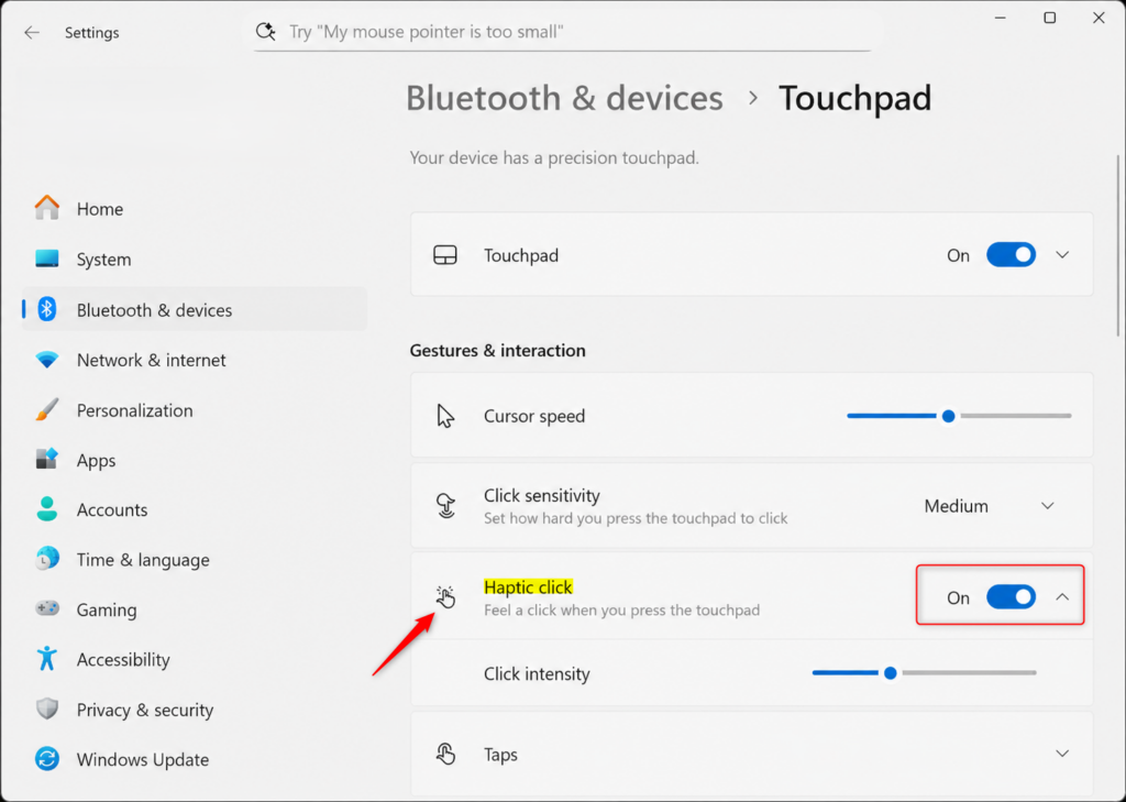 Windows 11 Settings screen showing touchpad haptic feedback options.