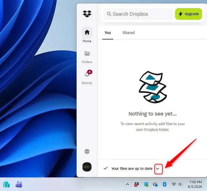Dropbox icon with a down arrow indicating pause sync option.