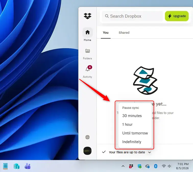 Pause sync option highlighted in Dropbox menu on Windows 11.